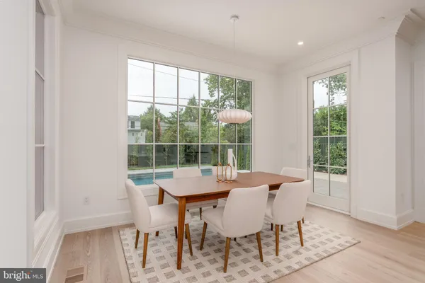 a dining room with furniture and wooden floor
