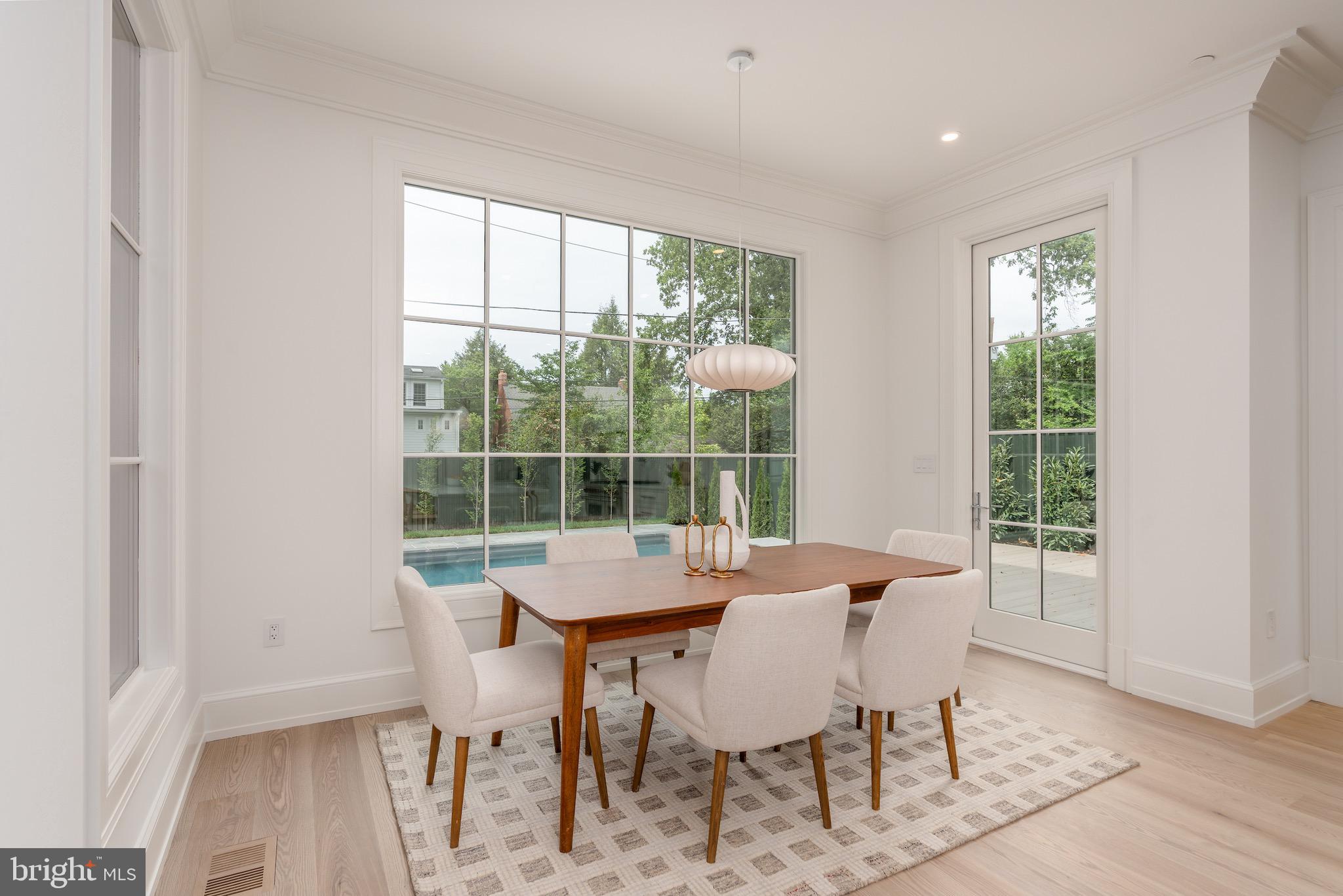 4821 Rodman Street Northwest Washington, DC 20016 - Photo 21 of 52 a dining room with furniture and wooden floor