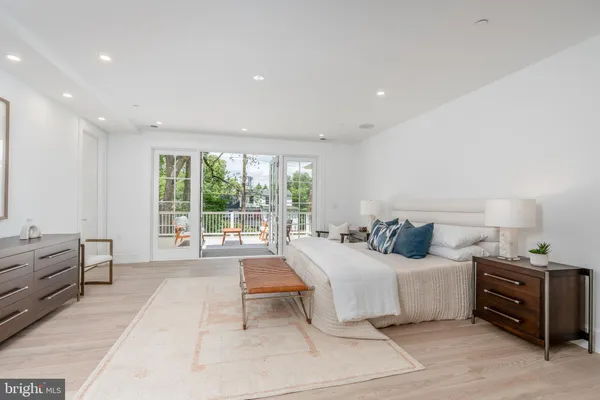 a bedroom with a large bed and a large window