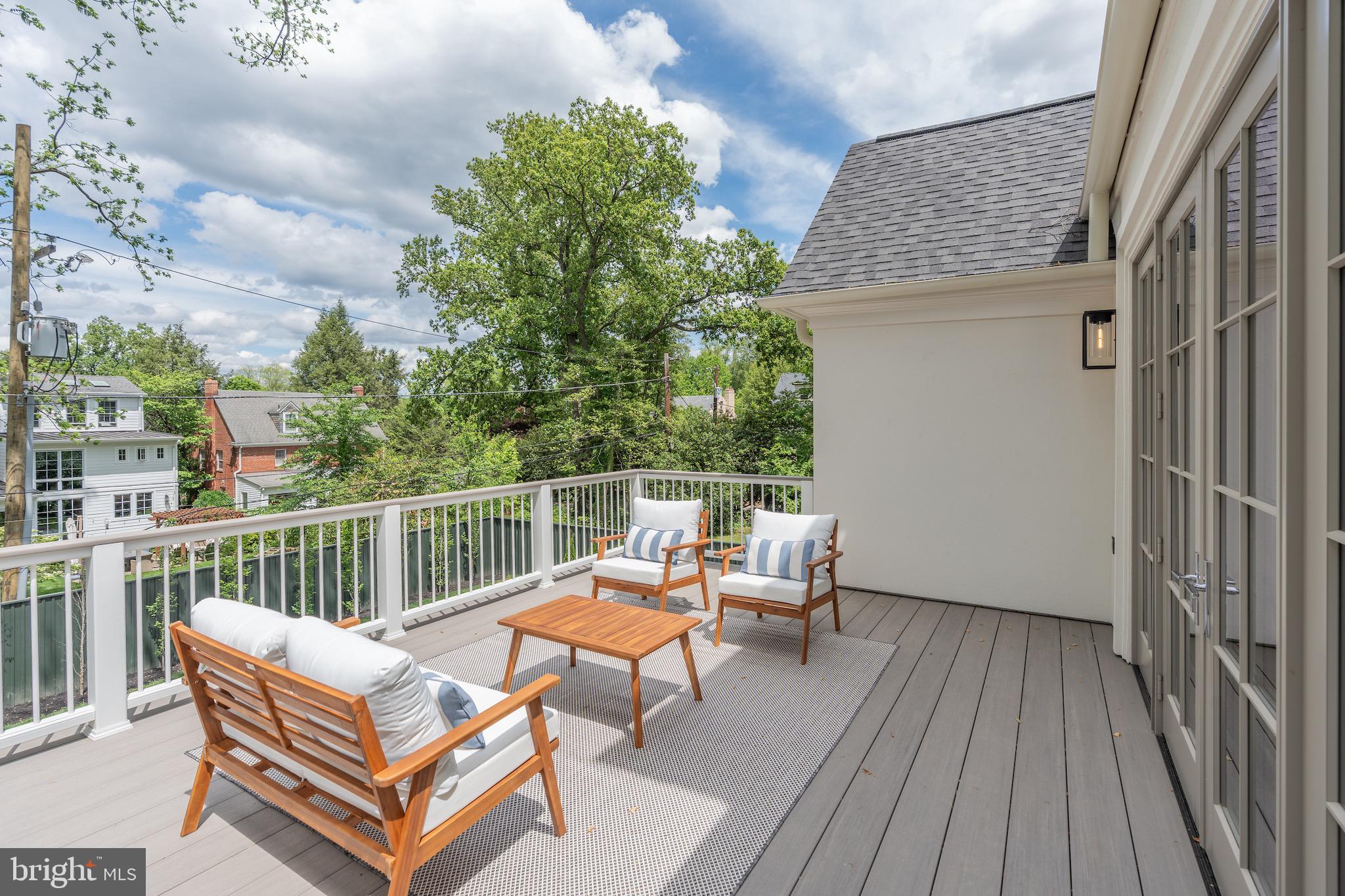 4821 Rodman Street Northwest Washington, DC 20016 - Photo 33 of 52 a roof deck with a table and chairs