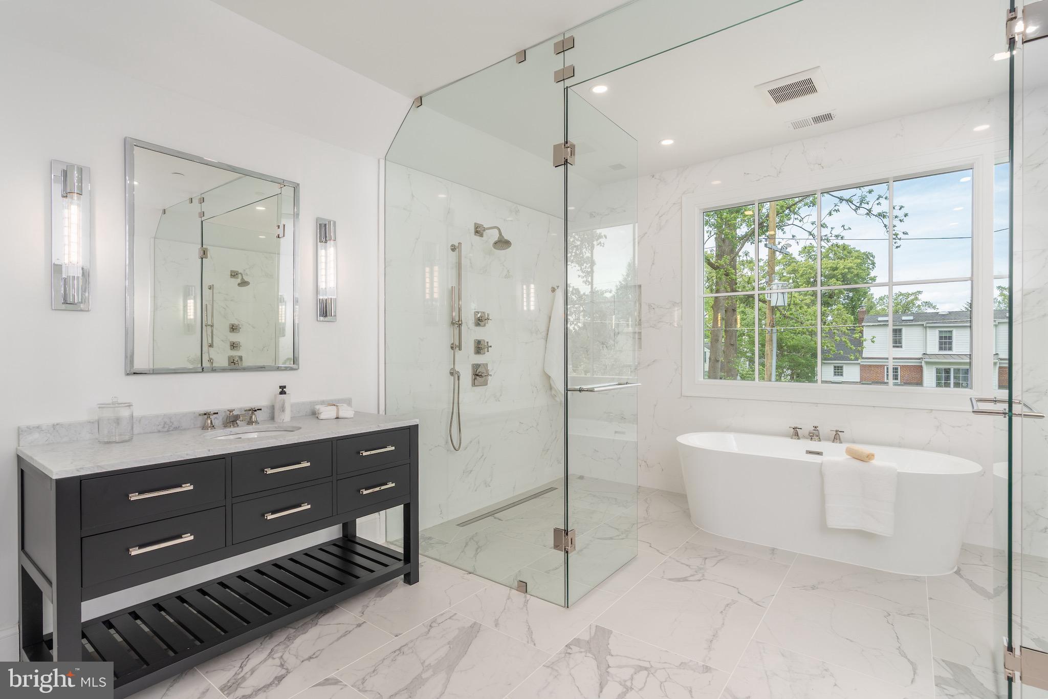 4821 Rodman Street Northwest Washington, DC 20016 - Photo 37 of 52 a spacious bathroom with a tub sink shower and mirror