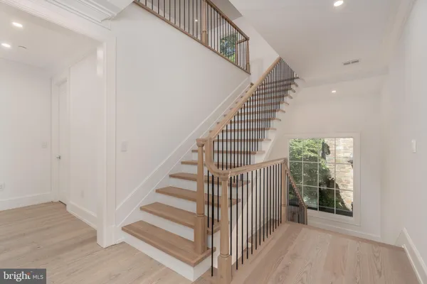 a view of entryway and hall with wooden floor