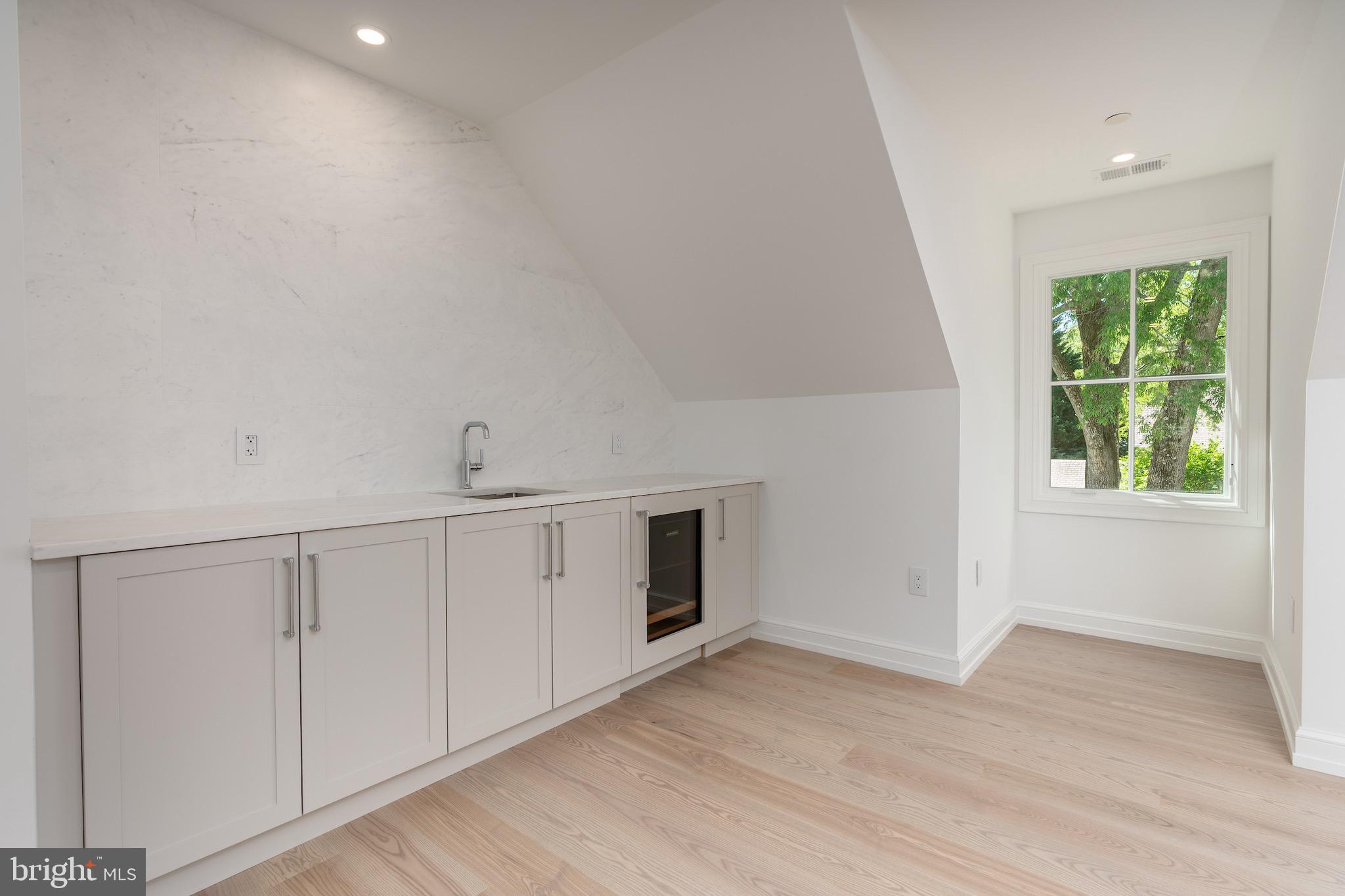 4821 Rodman Street Northwest Washington, DC 20016 - Photo 43 of 52 a view of an empty room with wooden floor and a window