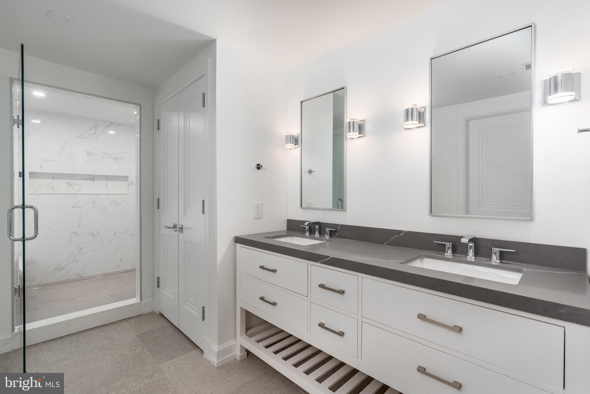 4821 Rodman Street Northwest Washington, DC 20016 - Photo 46 of 52 a bathroom with a granite countertop sink mirror and double