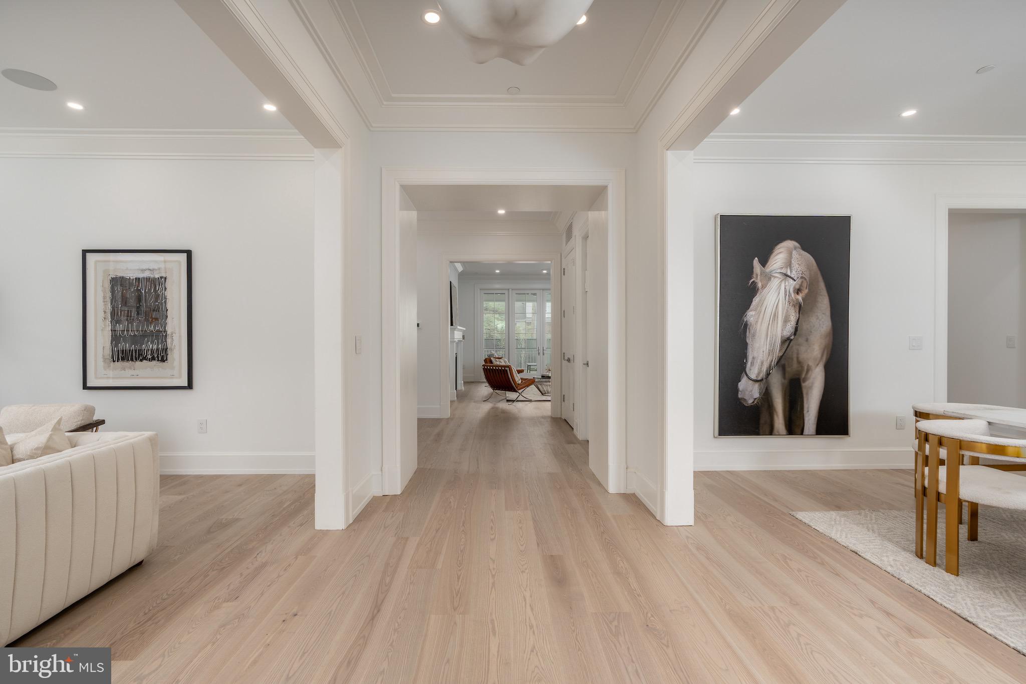 4821 Rodman Street Northwest Washington, DC 20016 - Photo 6 of 52 a view of a hallway with wooden floor and a living room