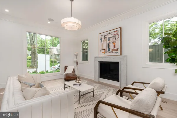 a living room with furniture chandelier and a fireplace