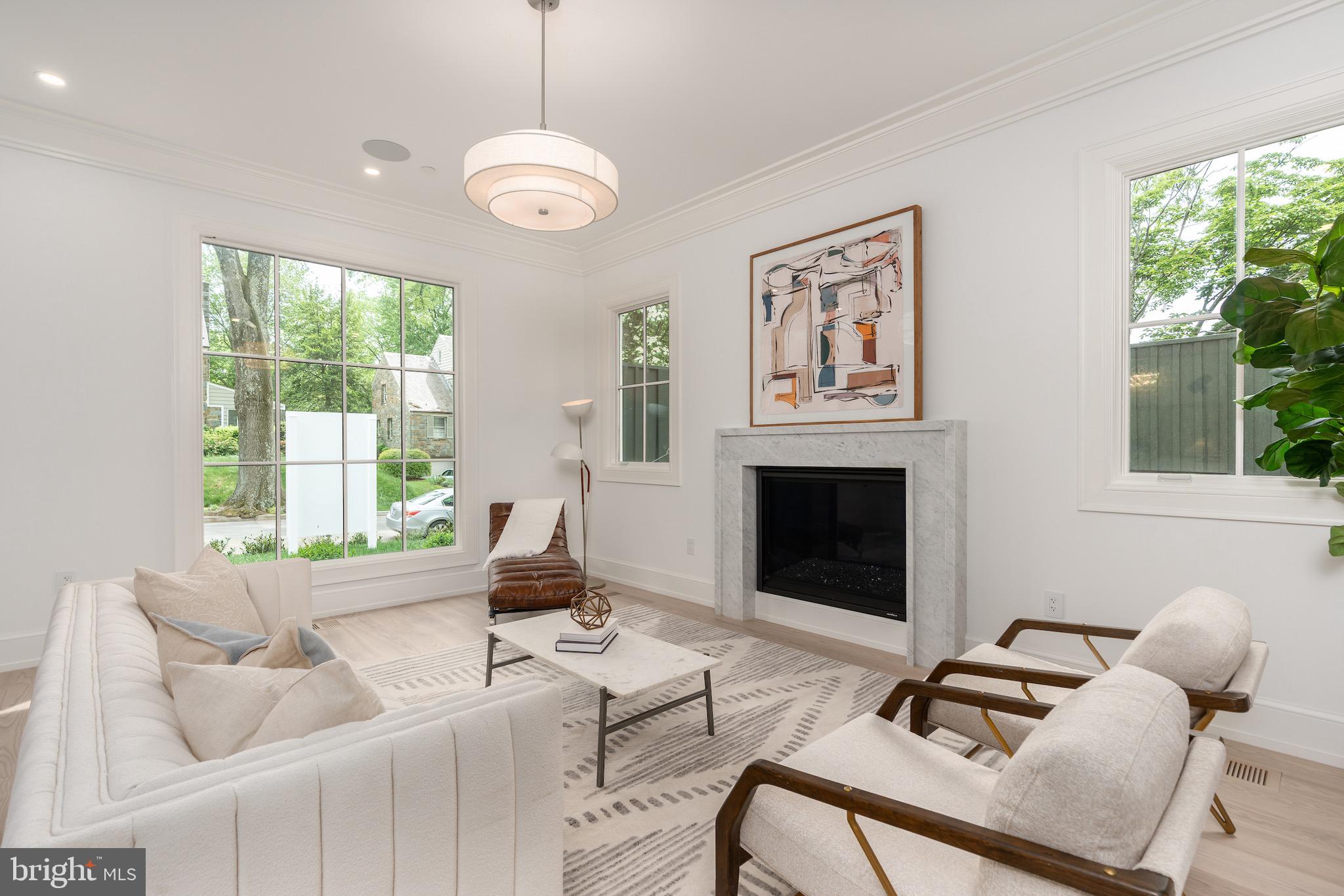 4821 Rodman Street Northwest Washington, DC 20016 - Photo 7 of 52 a living room with furniture chandelier and a fireplace