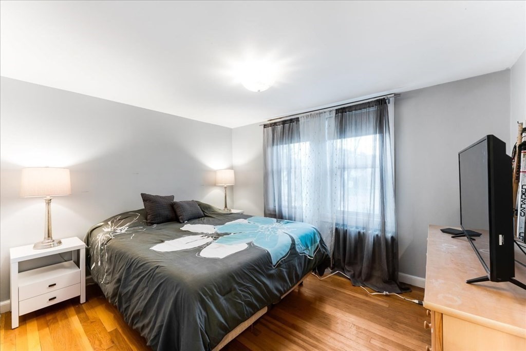 34 Julian Road Randolph, MA 02368 - Photo 17 of 19 a bedroom with a bed and a flat tv screen on a dresser