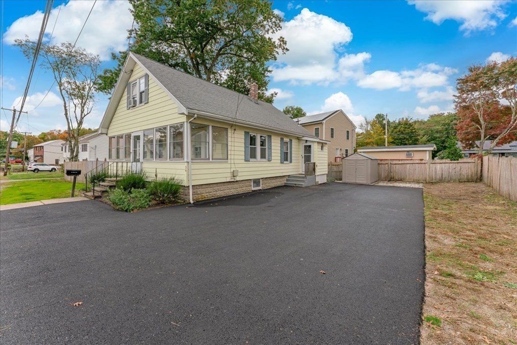 34 Julian Road Randolph, MA 02368 - Photo 2 of 19 a view of a white house next to a yard with big trees