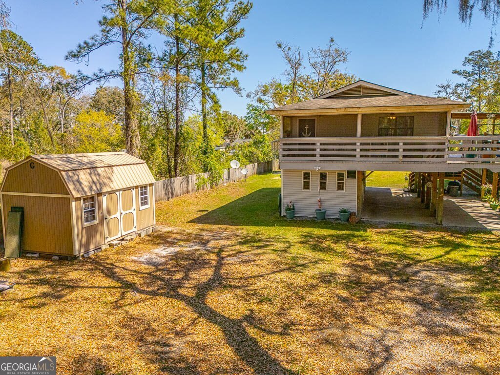 33 Warren Avenue Waverly, GA 31565 - Photo 59 of 63 a front view of a house with a yard