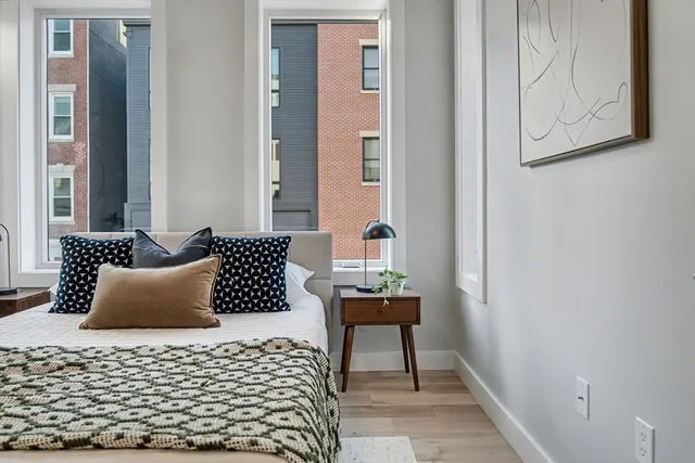 a bedroom with a bed and a lamp on table