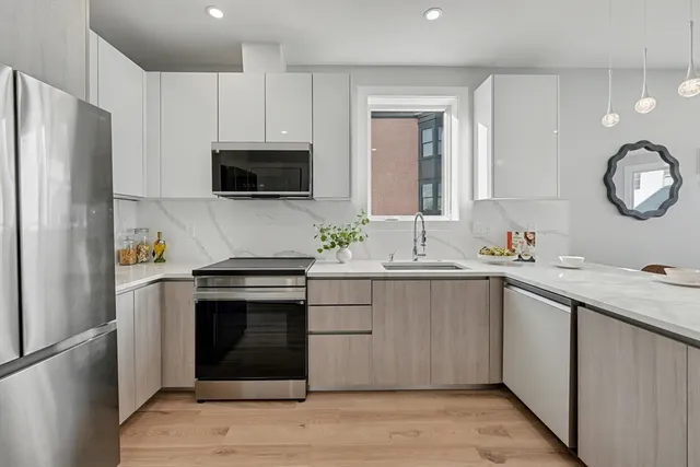 a kitchen with a sink stove and refrigerator