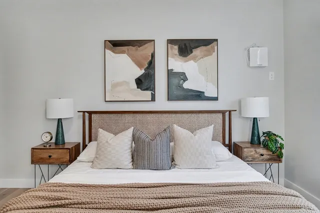 a bedroom with a bed and lamps