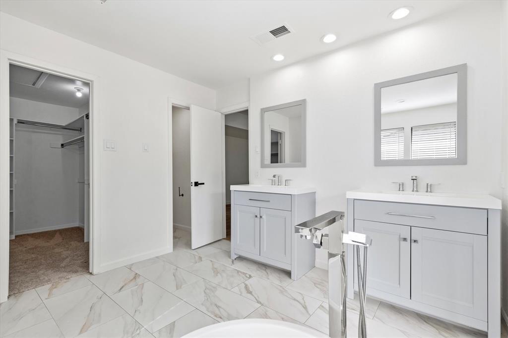 17003 Davenport Road Dallas, TX 75248 - Photo 26 of 40 a spacious bathroom with a double vanity sink a mirror and a bathtub