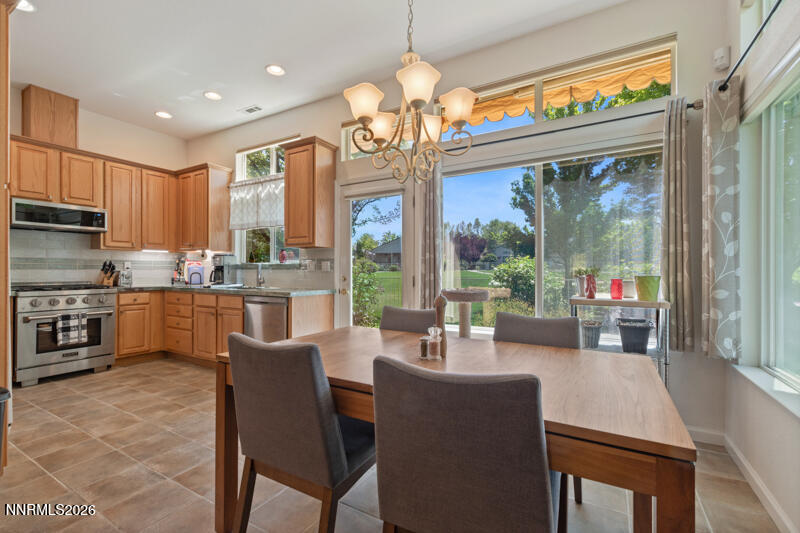 403 Sierra Leaf Circle Reno, NV 89511 - Photo 11 of 25 a very nice looking dining room with kitchen island furniture a large window and kitchen view