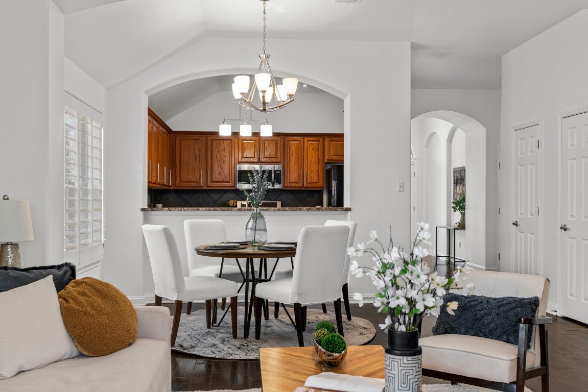 a view of a dining room with furniture and chandelier