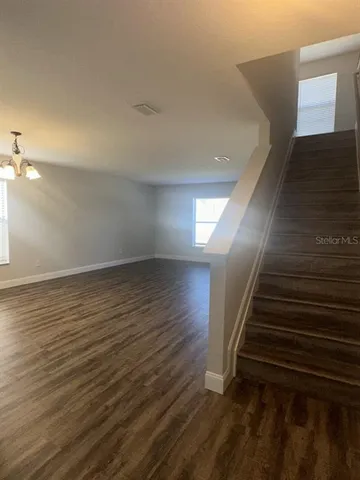 wooden floor in an empty room with stairs