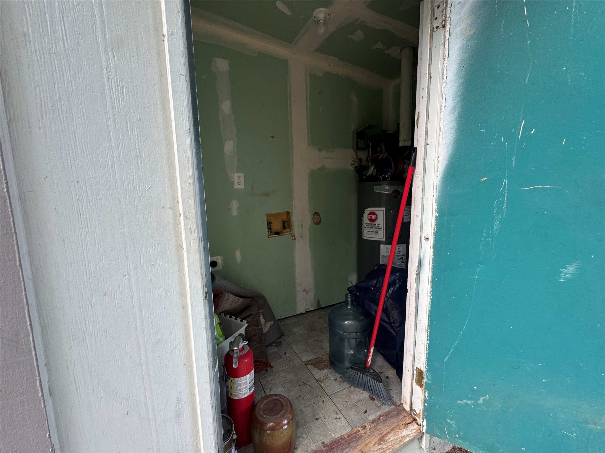 5007 Heflin Lane Austin, TX 78721 - Photo 24 of 25 A utility area offers functional space with essential household equipment and accessible storage.