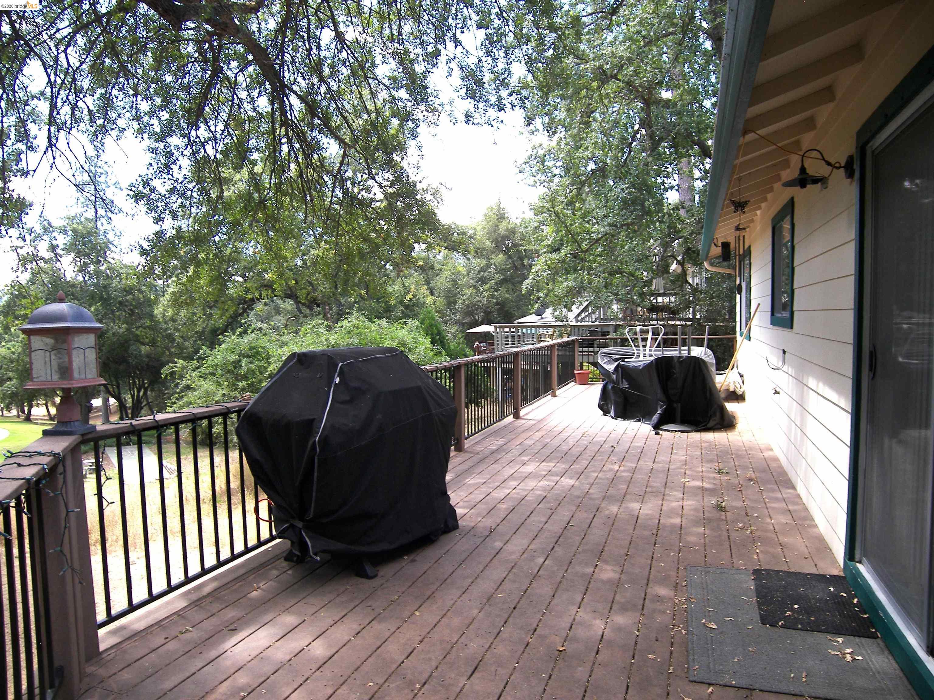 19215 Ferretti Road Groveland, CA 95321 - Photo 30 of 40 Expansive wood deck with dark railings overlooking Golf Course.