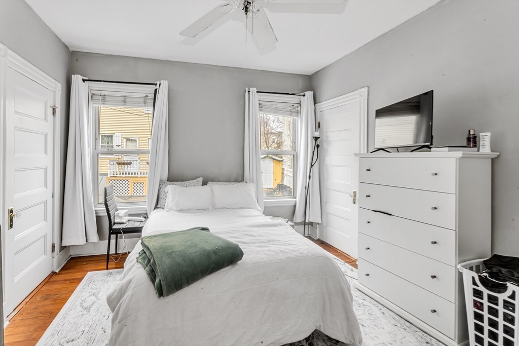 15 Bynner Street, Unit 1 Boston, MA 02130 - Photo 11 of 27 a bedroom with a bed and a flat tv screen on dresser