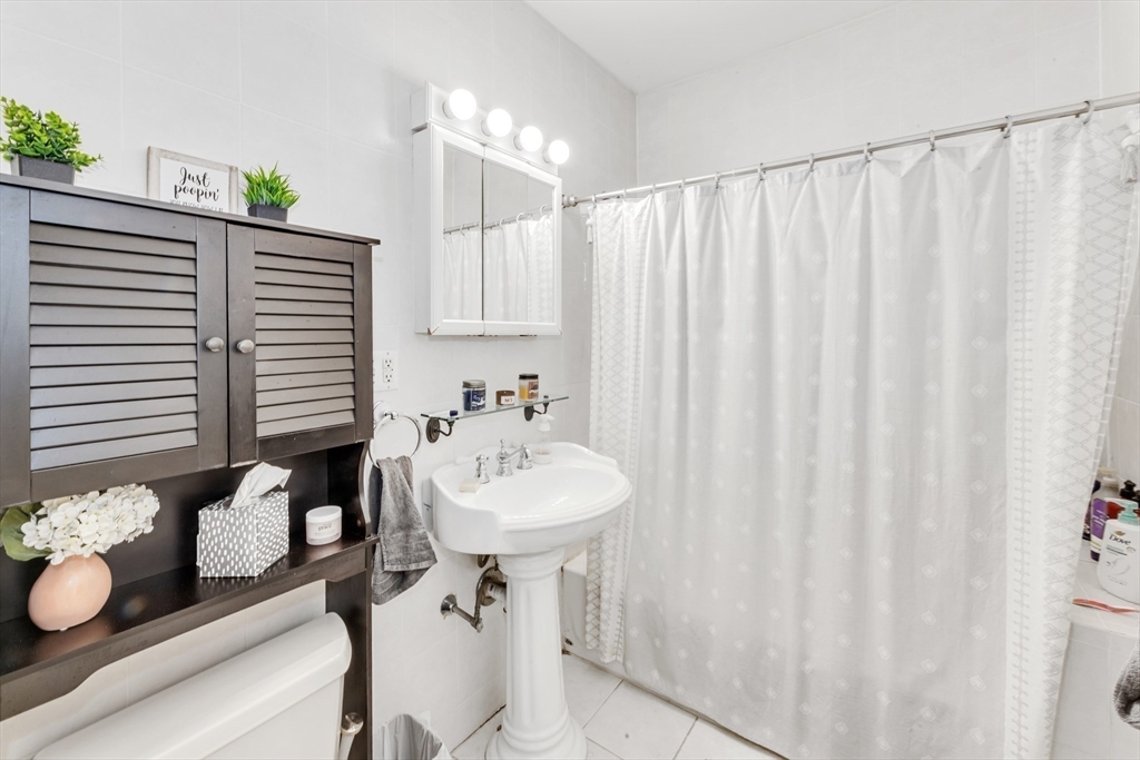 15 Bynner Street, Unit 1 Boston, MA 02130 - Photo 14 of 27 a bathroom with a sink and a mirror