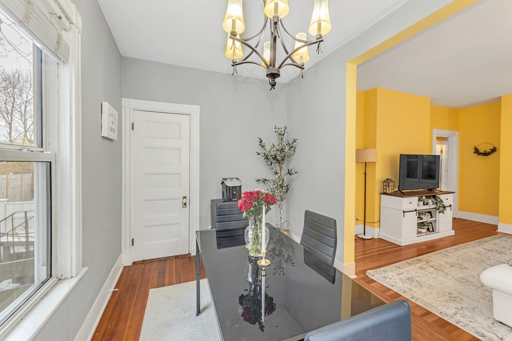 15 Bynner Street, Unit 1 Boston, MA 02130 - Photo 4 of 27 a view of a dining room with furniture a chandelier and wooden floor