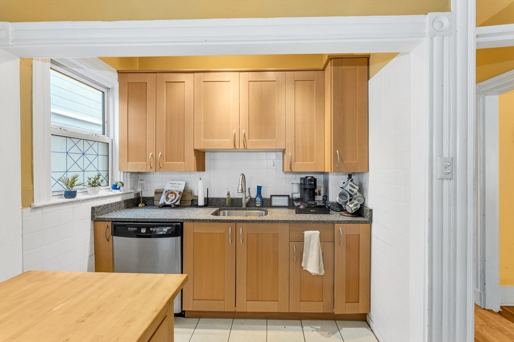 15 Bynner Street, Unit 1 Boston, MA 02130 - Photo 5 of 27 a kitchen with stainless steel appliances granite countertop a stove a sink and a microwave
