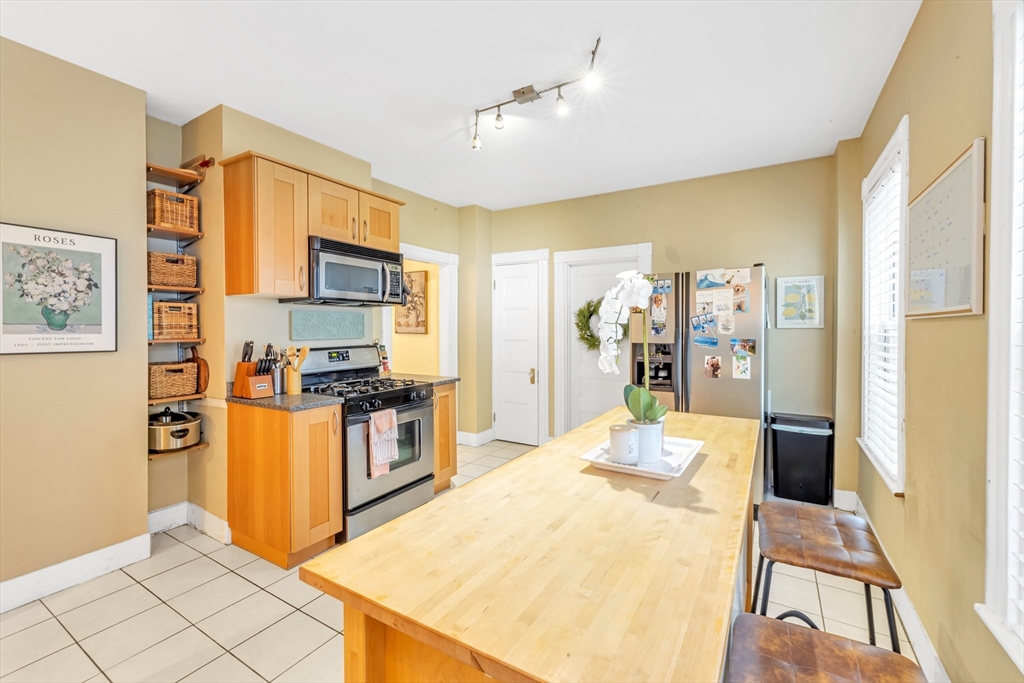 15 Bynner Street, Unit 1 Boston, MA 02130 - Photo 7 of 27 a kitchen with stainless steel appliances granite countertop a refrigerator and a stove top oven