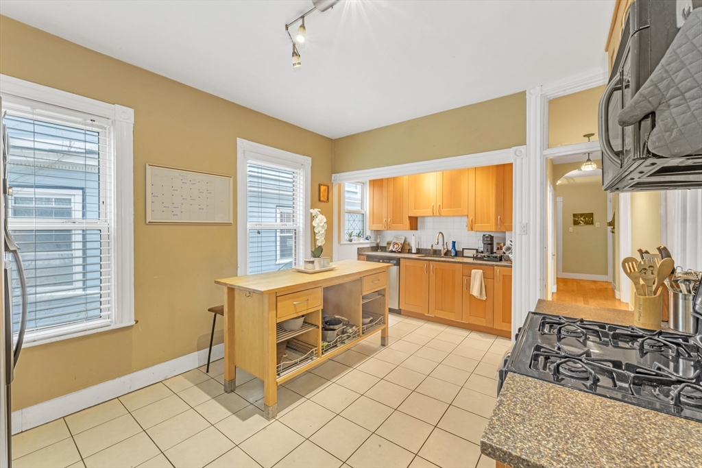 15 Bynner Street, Unit 1 Boston, MA 02130 - Photo 8 of 27 a kitchen with stainless steel appliances granite countertop a stove a sink and a microwave