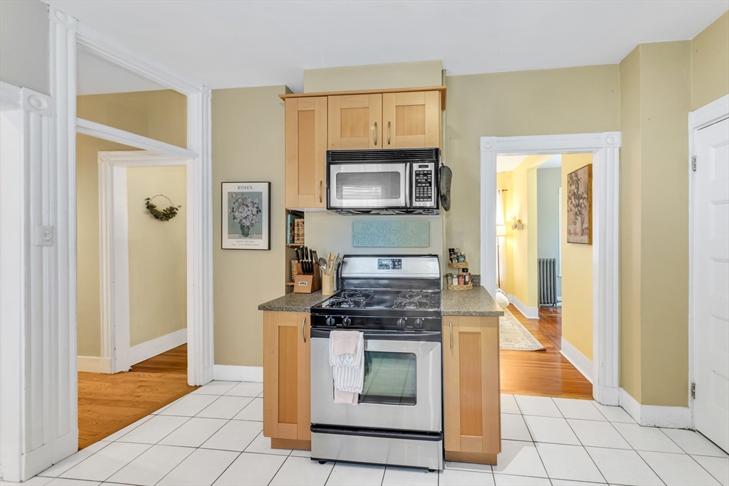 15 Bynner Street, Unit 1 Boston, MA 02130 - Photo 9 of 27 a kitchen with stainless steel appliances granite countertop a stove and a microwave