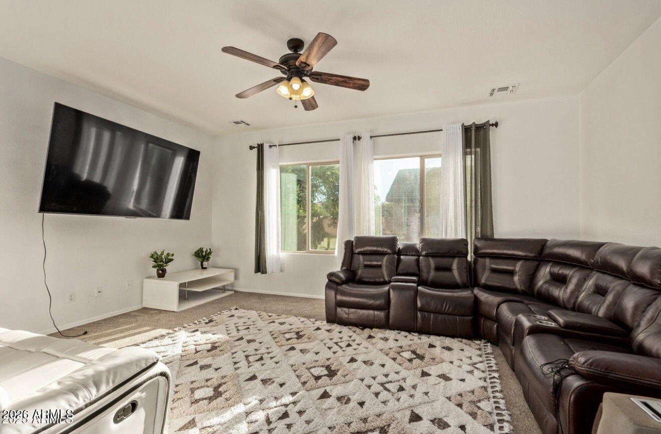 9171 West Berkeley Road Phoenix, AZ 85037 - Photo 11 of 36 a living room with furniture fireplace and a flat screen tv