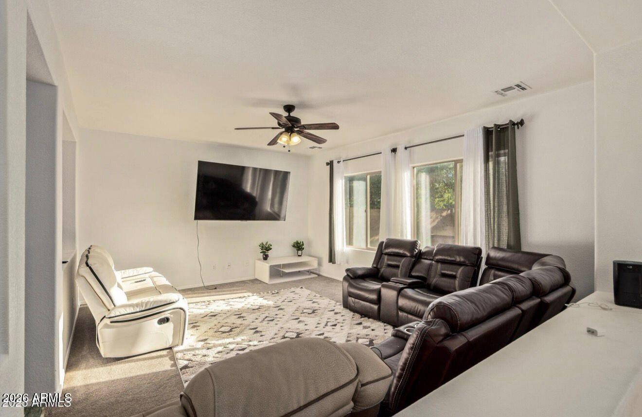 9171 West Berkeley Road Phoenix, AZ 85037 - Photo 12 of 36 a living room with furniture and a flat screen tv