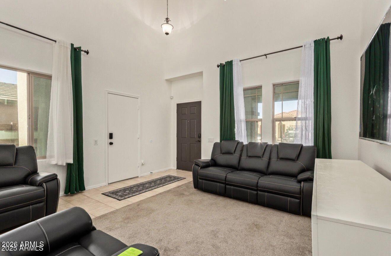 9171 West Berkeley Road Phoenix, AZ 85037 - Photo 13 of 36 a living room with furniture and a window