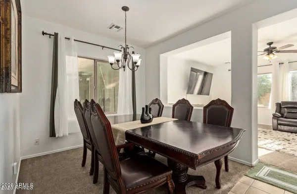 a view of a dining room with furniture and a chandelier