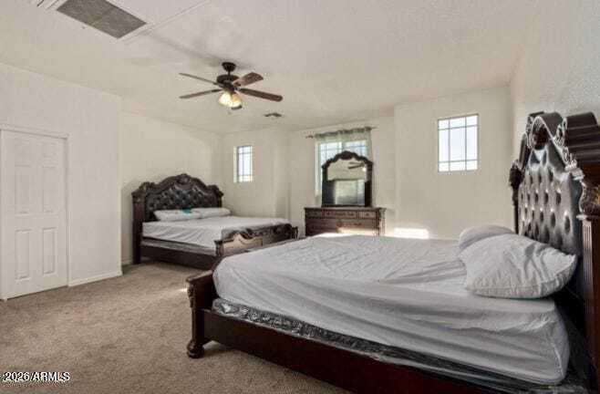 9171 West Berkeley Road Phoenix, AZ 85037 - Photo 15 of 36 a bedroom with a bed and a chandelier