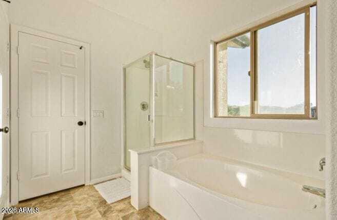 9171 West Berkeley Road Phoenix, AZ 85037 - Photo 17 of 36 a bathroom with a bathtub and shower