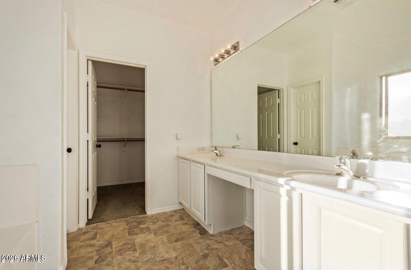 9171 West Berkeley Road Phoenix, AZ 85037 - Photo 25 of 36 a bathroom with a sink and a mirror