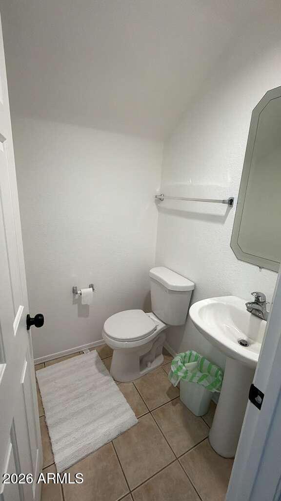 9171 West Berkeley Road Phoenix, AZ 85037 - Photo 28 of 36 a white toilet sitting next to a bathroom sink