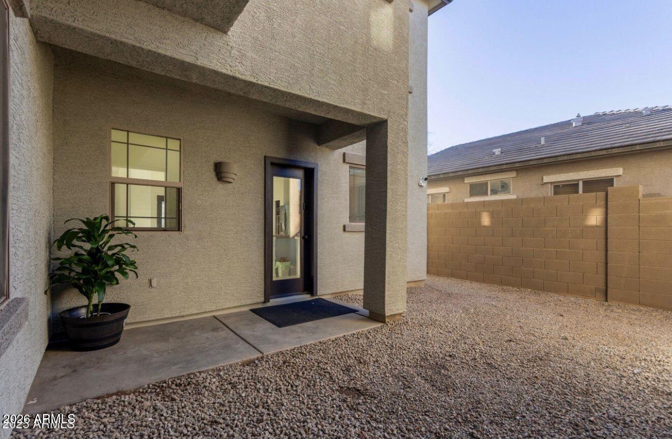 9171 West Berkeley Road Phoenix, AZ 85037 - Photo 32 of 36 a view of a house with a potted plant and floor to ceiling window