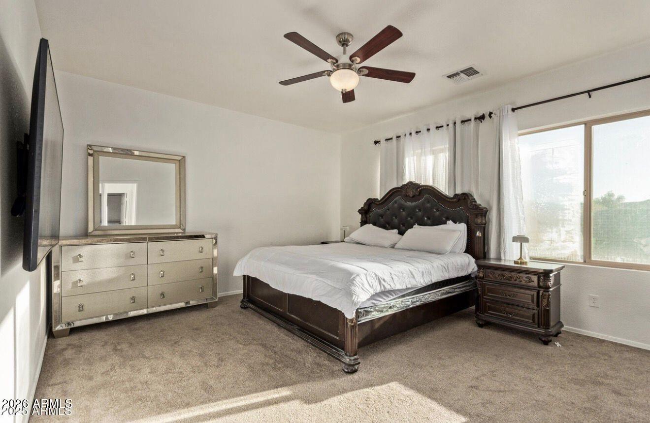 9171 West Berkeley Road Phoenix, AZ 85037 - Photo 35 of 36 a bedroom with a bed dresser and a window