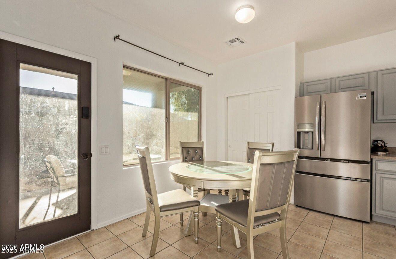 9171 West Berkeley Road Phoenix, AZ 85037 - Photo 4 of 36 a dining room with furniture and a window