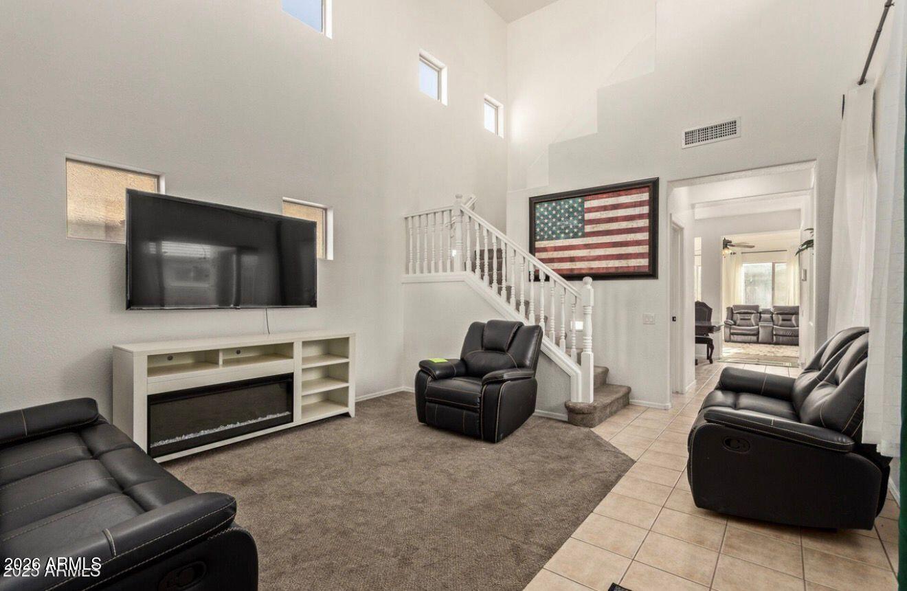 9171 West Berkeley Road Phoenix, AZ 85037 - Photo 7 of 36 a living room with furniture and a flat screen tv