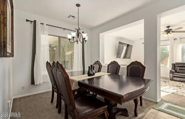 a view of a dining room with furniture and a chandelier