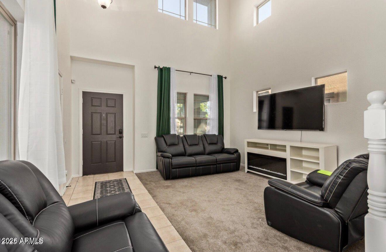 9171 West Berkeley Road Phoenix, AZ 85037 - Photo 10 of 36 a living room with furniture and a flat screen tv