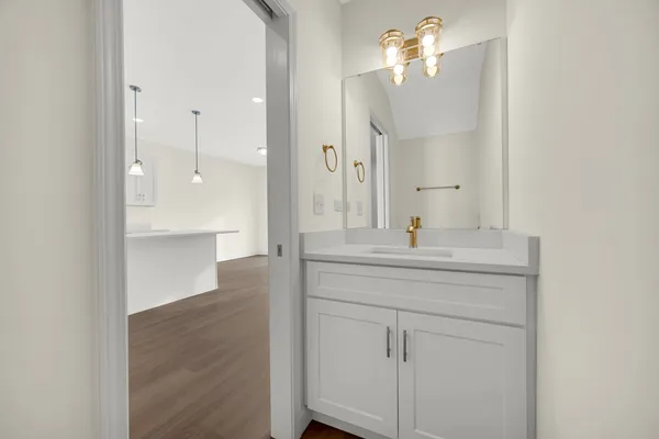 a bathroom with a sink a mirror and a shower