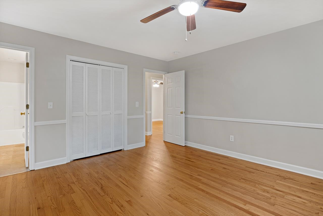 3517 Brecknock Street Durham, NC 27705 - Photo 21 of 38 an empty room with wooden floor fan and windows