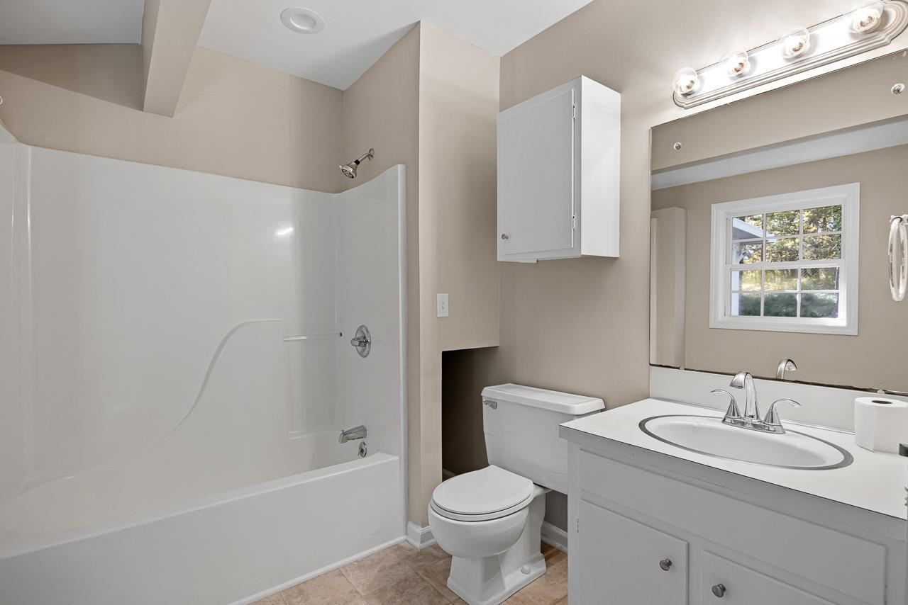 3517 Brecknock Street Durham, NC 27705 - Photo 22 of 38 a bathroom with a granite countertop sink toilet and shower