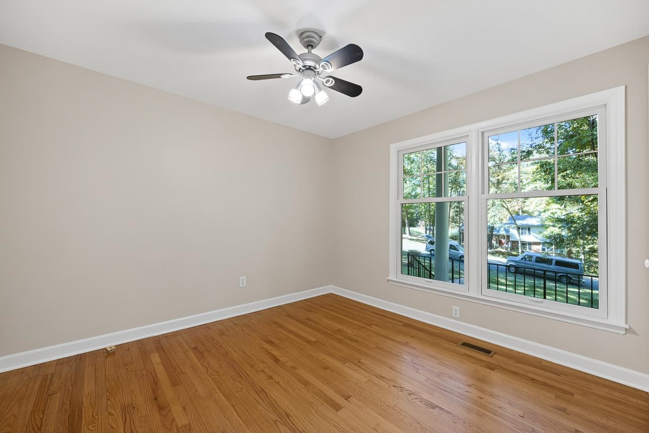3517 Brecknock Street Durham, NC 27705 - Photo 23 of 38 a view of an empty room with wooden floor and a window