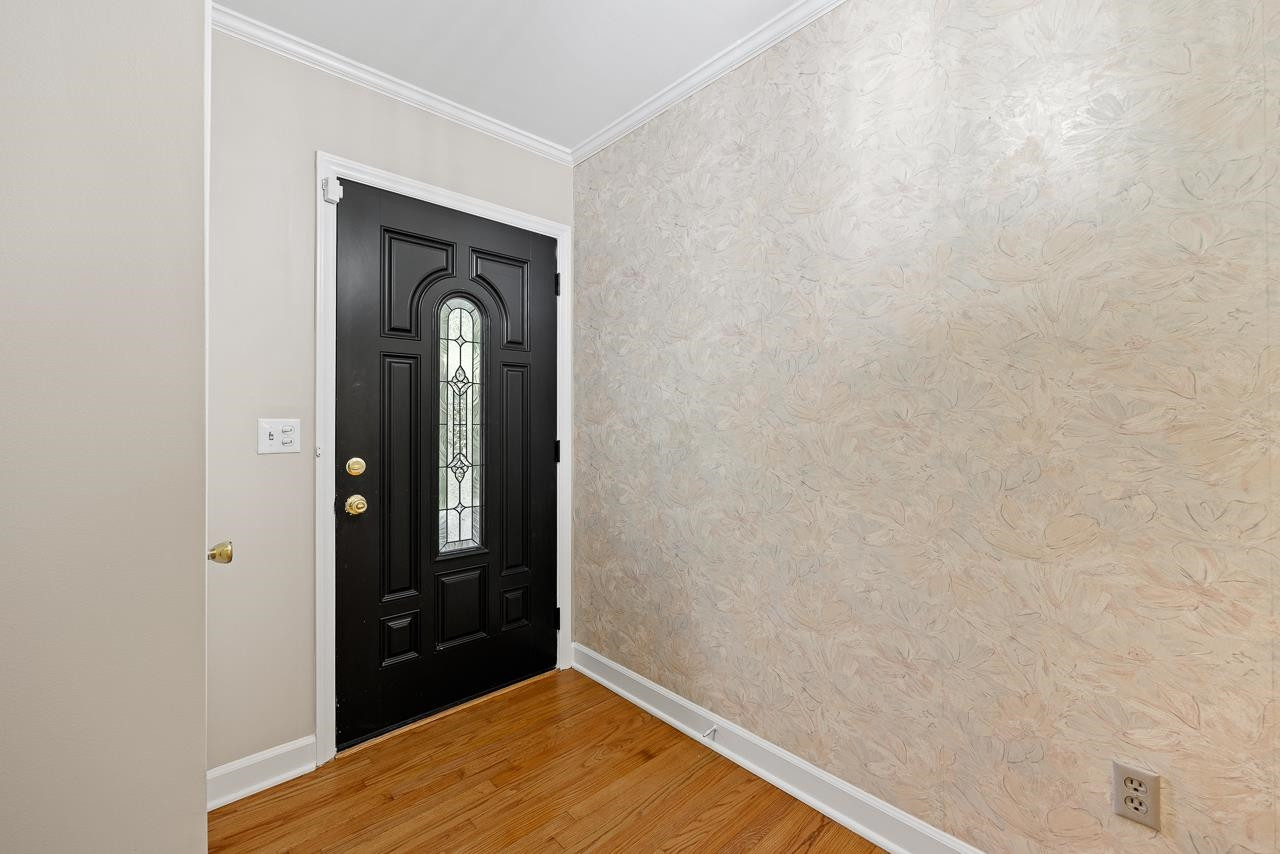 3517 Brecknock Street Durham, NC 27705 - Photo 3 of 38 a view of a hallway with wooden floor