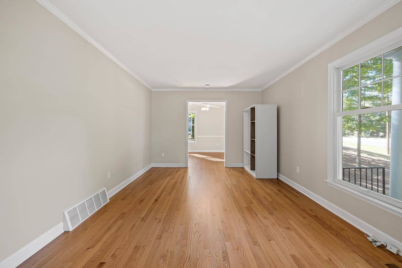 3517 Brecknock Street Durham, NC 27705 - Photo 4 of 38 a view of an empty room with wooden floor and a window
